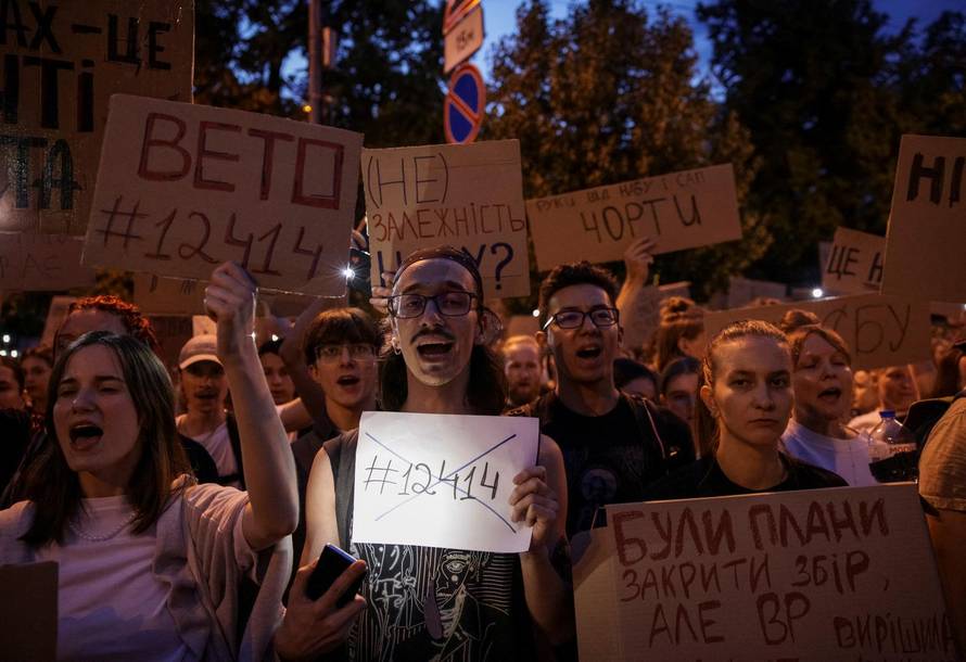 Ukrainians protest against a newly passed law, which curbs independence of anti-corruption institutions near the presidential office in Kyiv