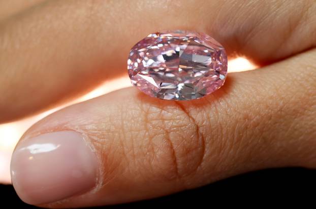 FILE PHOTO: A model poses with "The Spirit of the Rose" purple-pink diamond in Geneva