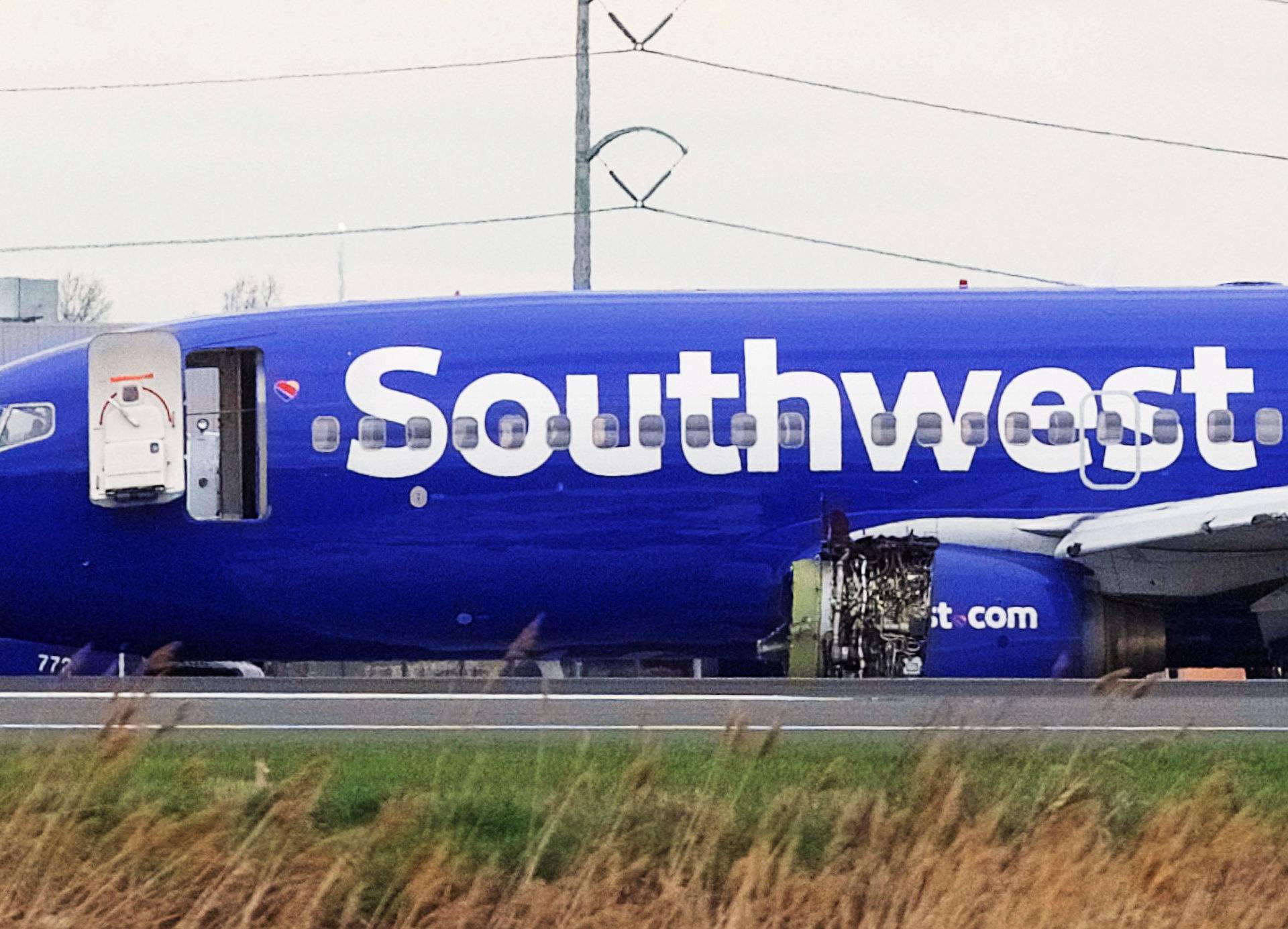 Emergency personnel monitor the damaged engine of Southwest Airlines Flight 1380, which diverted to the Philadelphia International Airport this morning, in Philadelphia, Pennsylvania