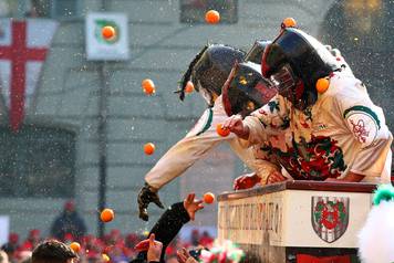 Members of rival teams fight with oranges during an annual carnival battle in the northern Italian town of Ivrea