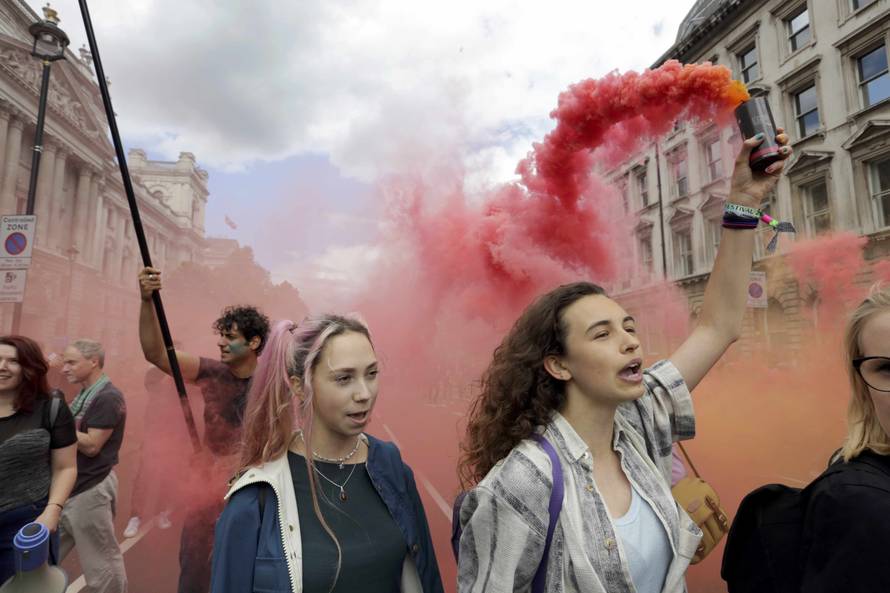 A womand holds a flare during a 'March for Europe' demonstration against Britain's decision to leave the European Union, in Parliament Square, central London