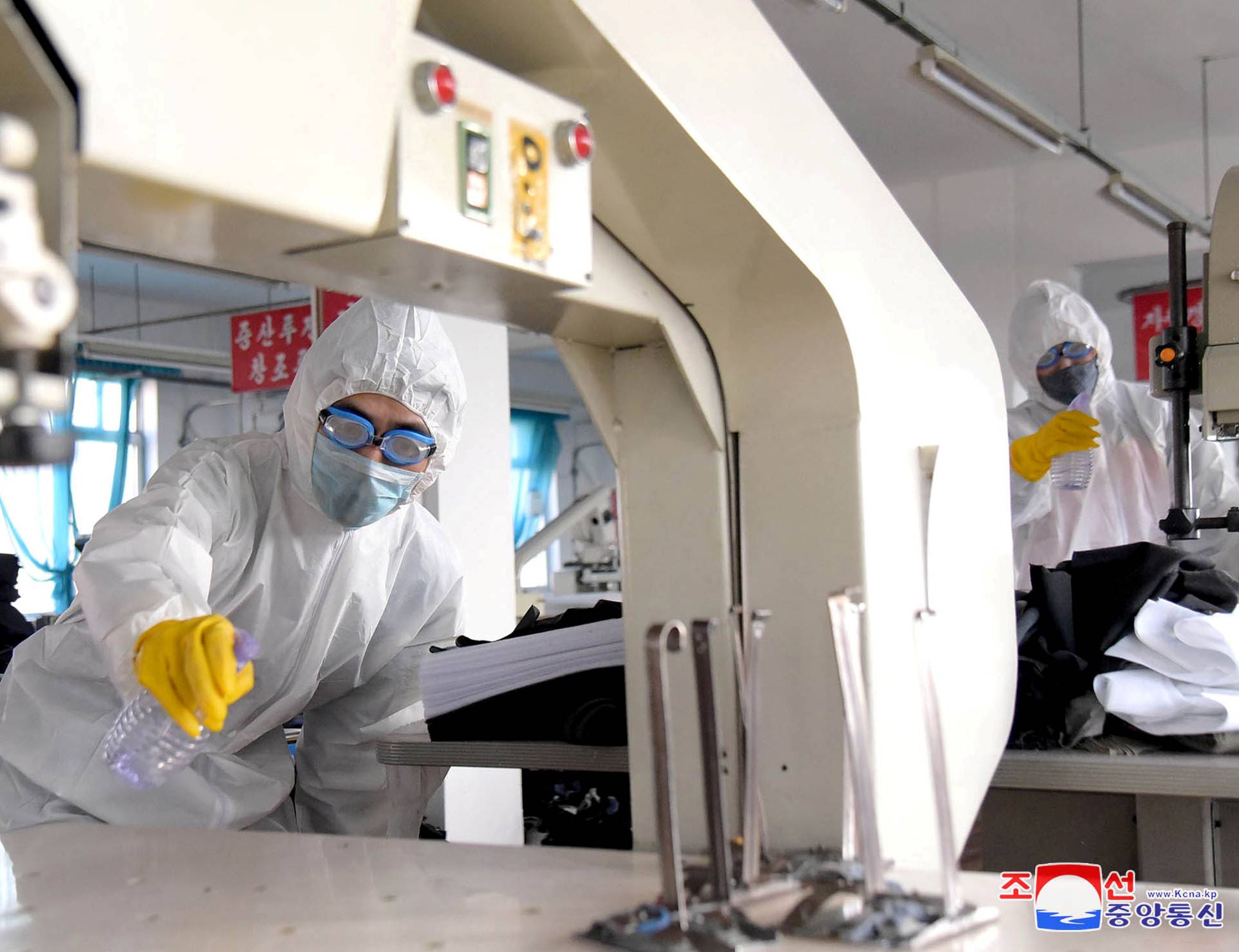 FILE PHOTO: KCNA picture of volunteers carrying out disinfection work during an anti-virus campaign in Pyongyang