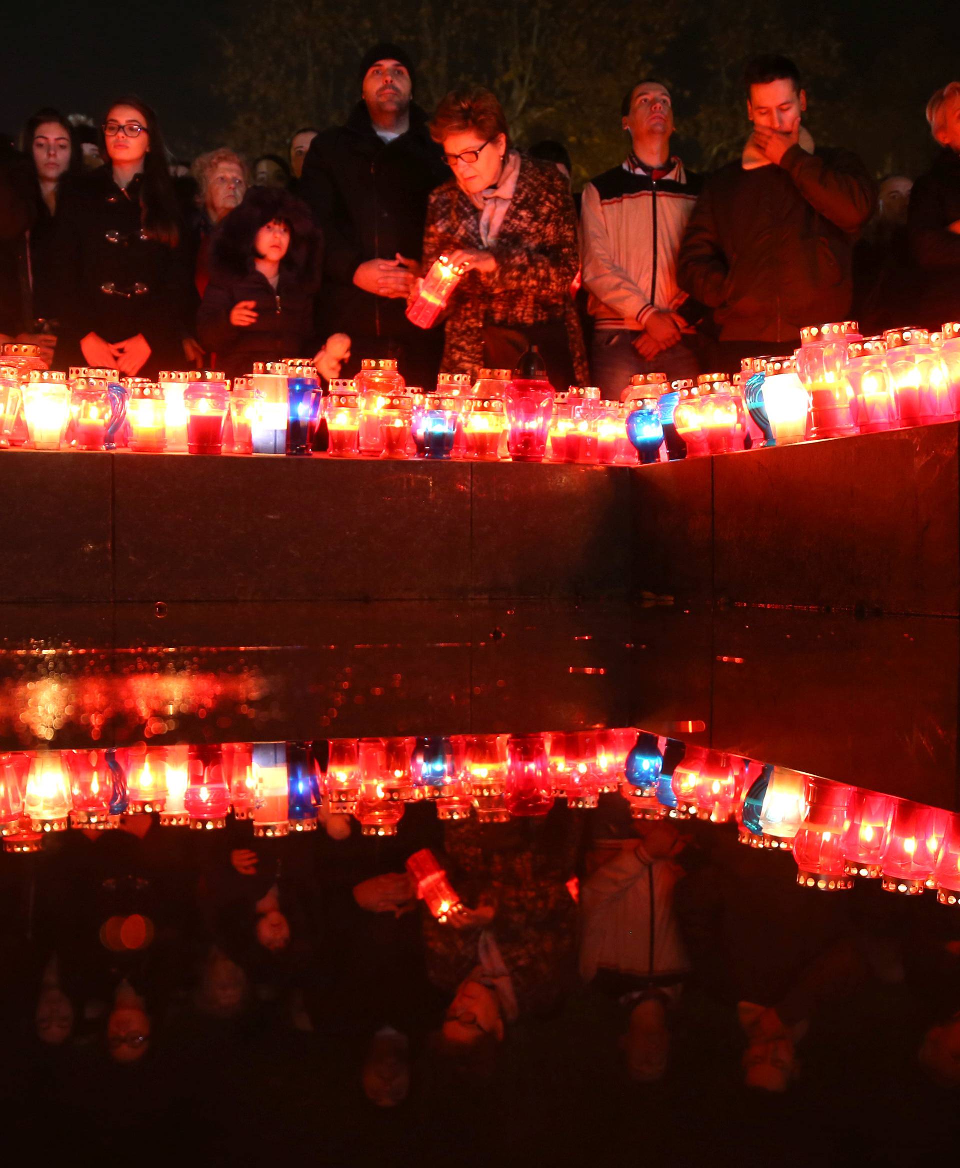 Bosnian Croats pray and light candles for the convicted general Slobodan Praljak who killed himself seconds after the verdict in the U.N. war crimes tribunal in The Hague, in Mostar