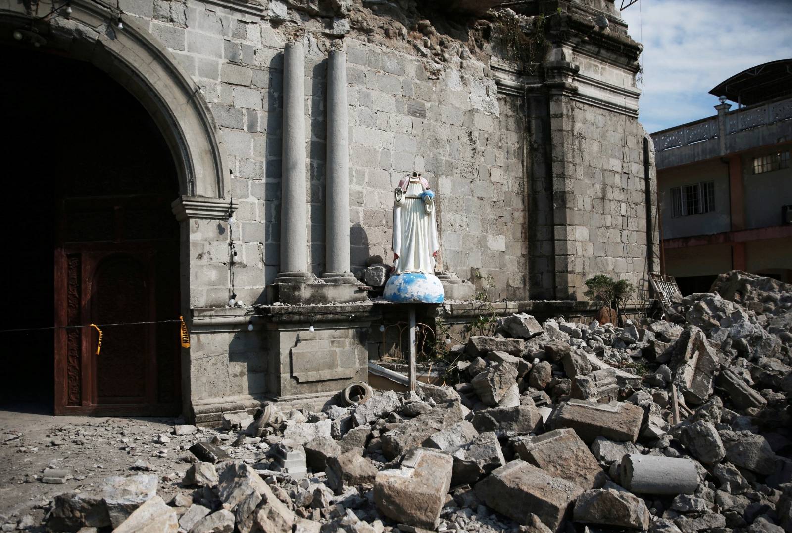 Debris and rubble surround the Santa Catalina de Alejandria Parish after an earthquake the day before in Porac town