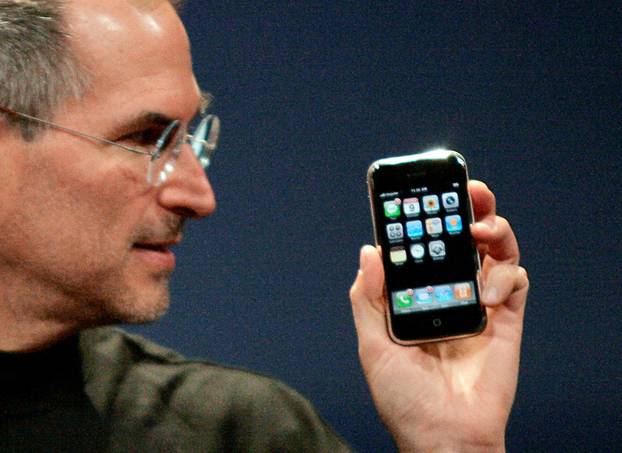 FILE PHOTO: Apple Chief Executive Officer Steve Jobs holds new iPhone in San Francisco