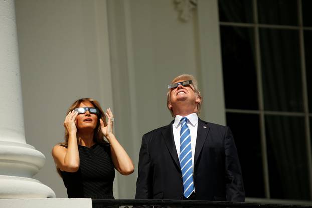 U.S. President Trump watches the solar eclipse with first Lady Melania Trump from the Truman Balcony at the White House in Washington