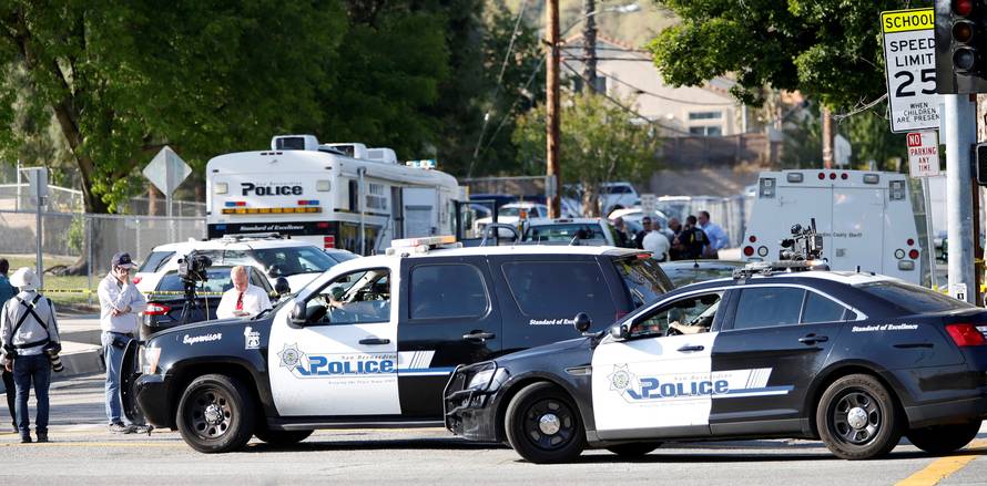 Police vehicles are pictured after a shooting at North Park Elementary School in San Bernardino