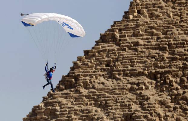 Professional skydiver flies over a pyramid in Giza