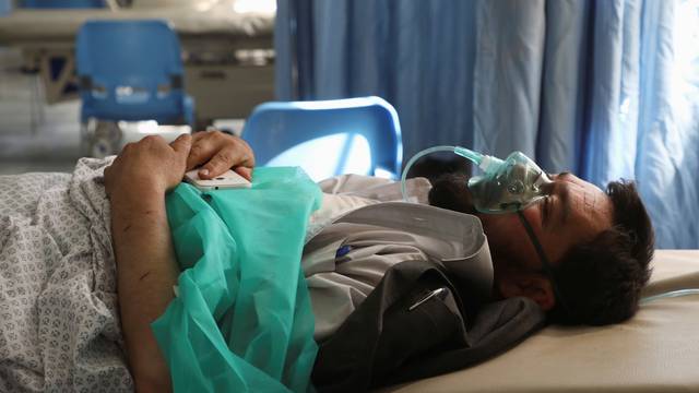 A wounded man receives treatment at a hospital after a blast in Kabul, Afghanistan