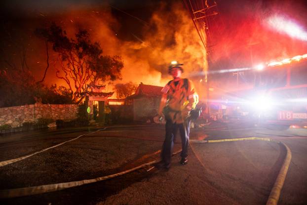 Palisades fire burns during a windstorm on the west side of Los Angeles