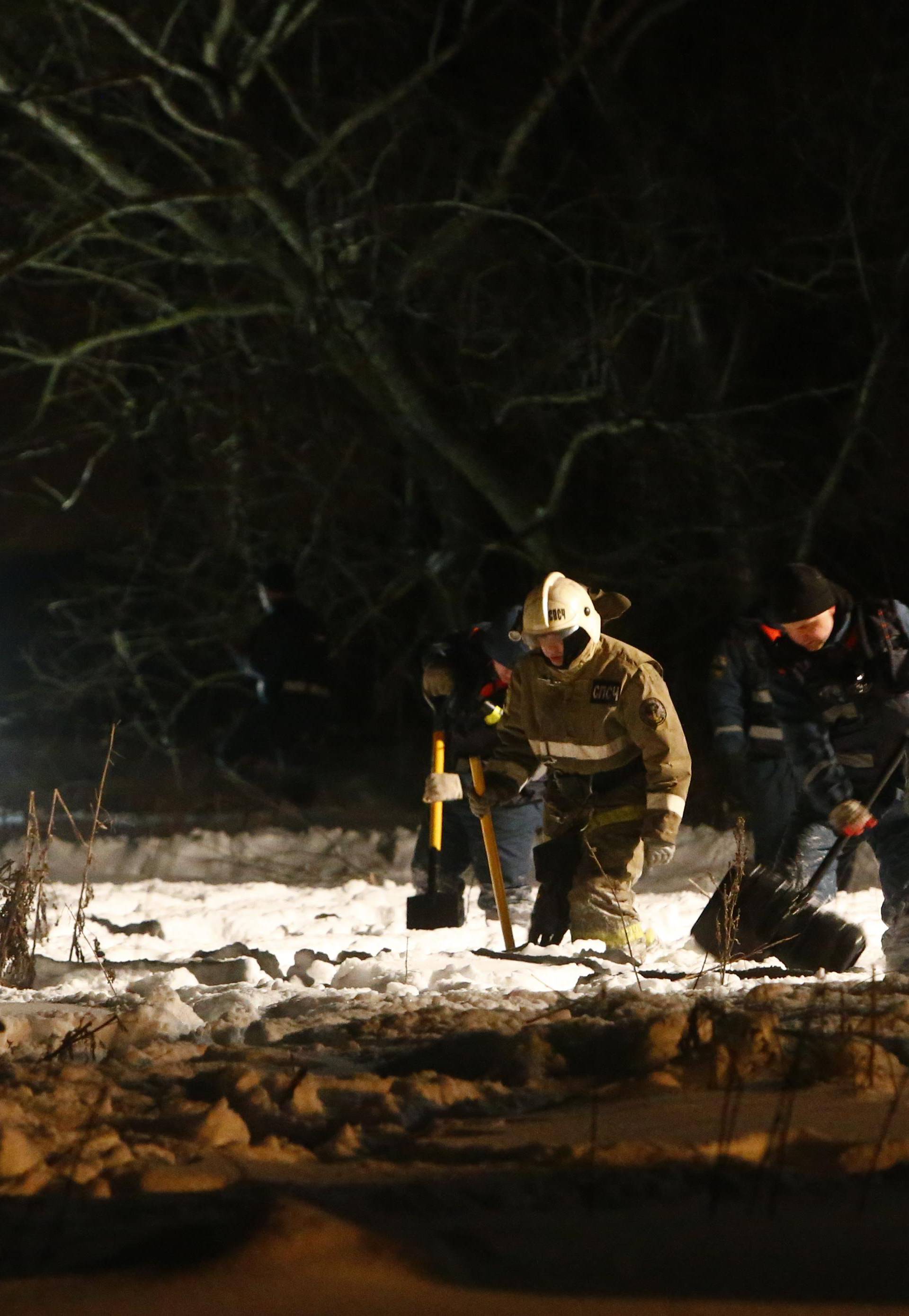 Emergency services work at the scene where a Saratov Airlines Antonov AN-148 plane crashed after taking off from Moscow's Domodedovo airport, outside Moscow