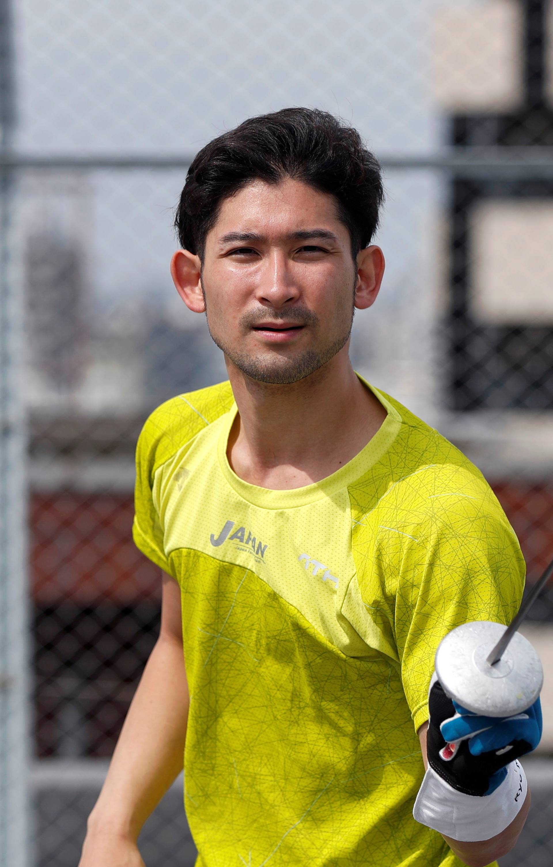 Japan's Olympic fencing medallist Ryo Miyake trains at the rooftop of his apartment as the spread of the coronavirus disease (COVID-19) continues in Tokyo