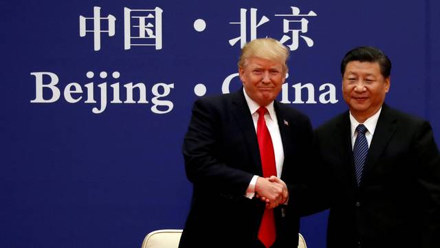 FILE PHOTO: FILE PHOTO: U.S. President Donald Trump and China's President Xi Jinping meet business leaders at the Great Hall of the People in Beijing