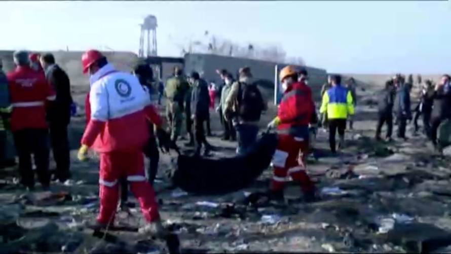 Emergency workers work near the wreckage of Ukraine International Airlines flight PS752, a Boeing 737-800 plane that crashed after taking off from Tehran's Imam Khomeini airport