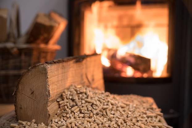 Wood,Stove,Heating,With,In,Foreground,Wood,Pellets,-,Economical