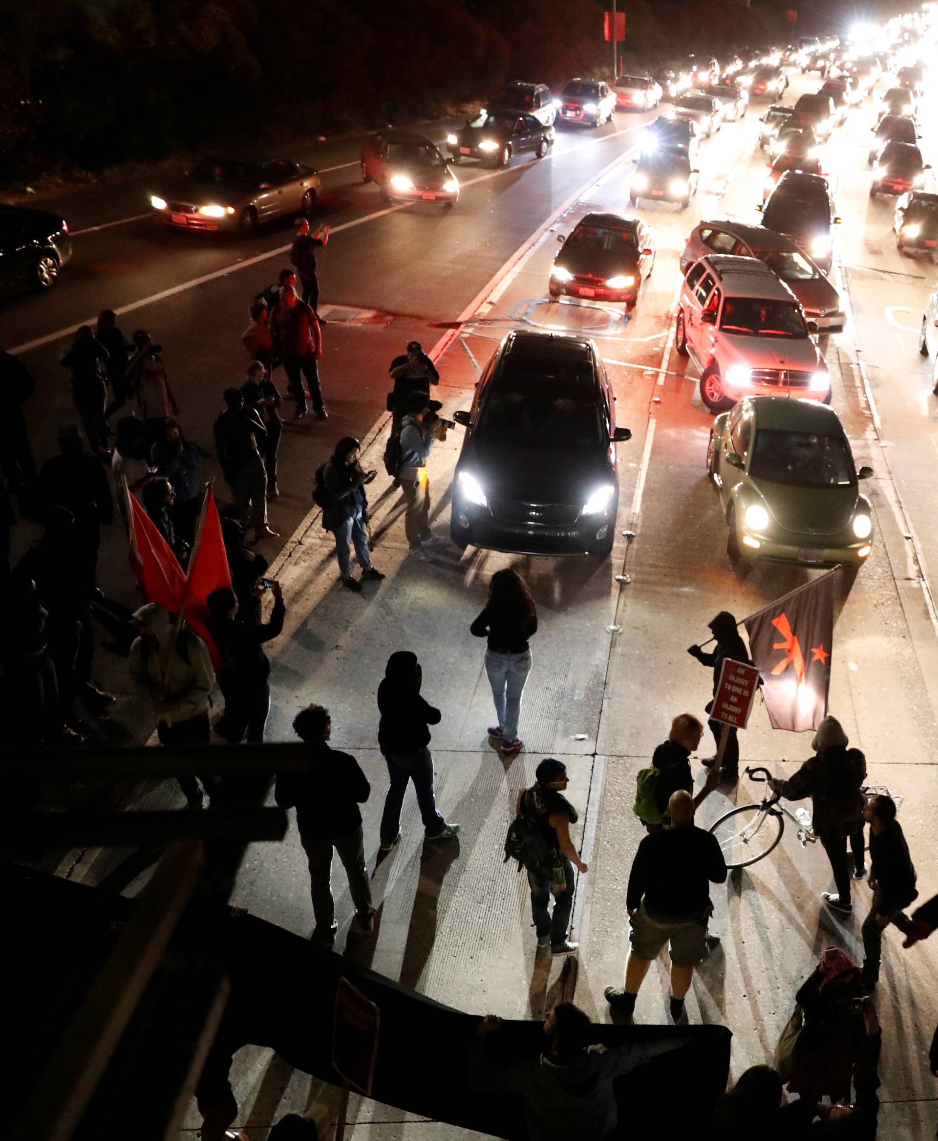 Demonstrators protesting the violence over the Virginia protests demonstrate by closing down the freeway in Oakland