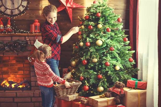 happy family mother and child girl decorated Christmas tree