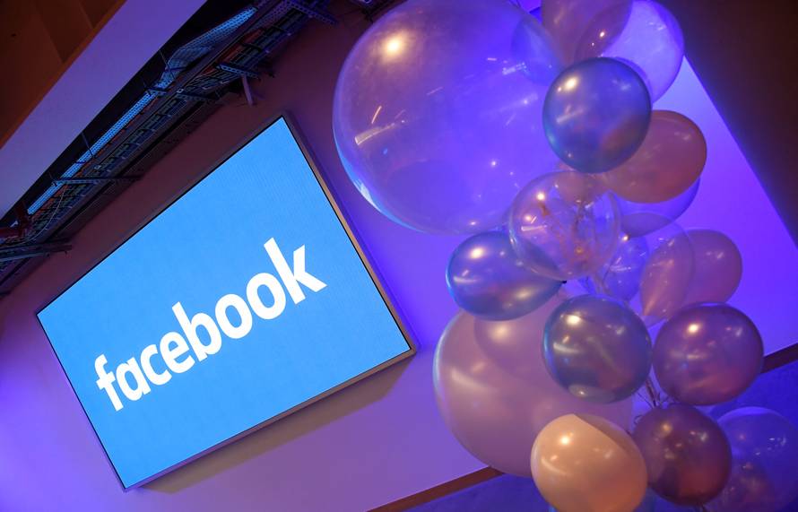 Balloons are seen in front of a logo at Facebook's headquarters in London