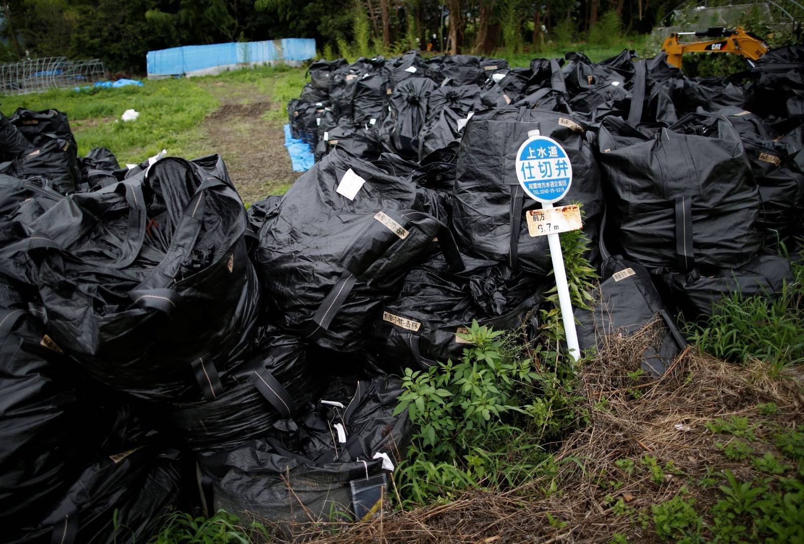 FILE PHOTO: Waste containing irradiated soil, leaves and debris from the decontamination operation are collected in Naraha town, Fukushima prefecture