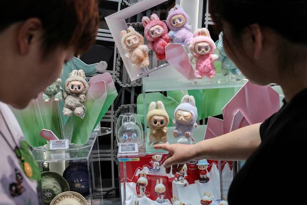 People look at Labubu dolls at the flagship store of Pop Mart in Shanghai