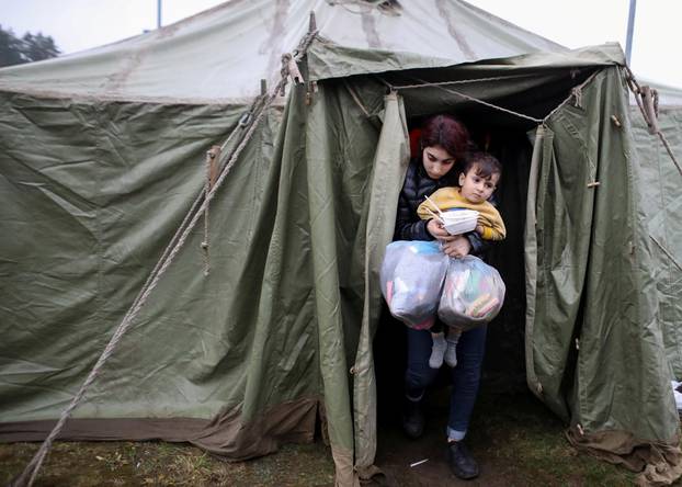 Migrants gather to receive food near the Belarusian-Polish border in the Grodno region