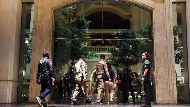 Policemen walk inside Grand Hyatt Erawan hotel, which believed that at least 6 people have been reported dead in Bangkok