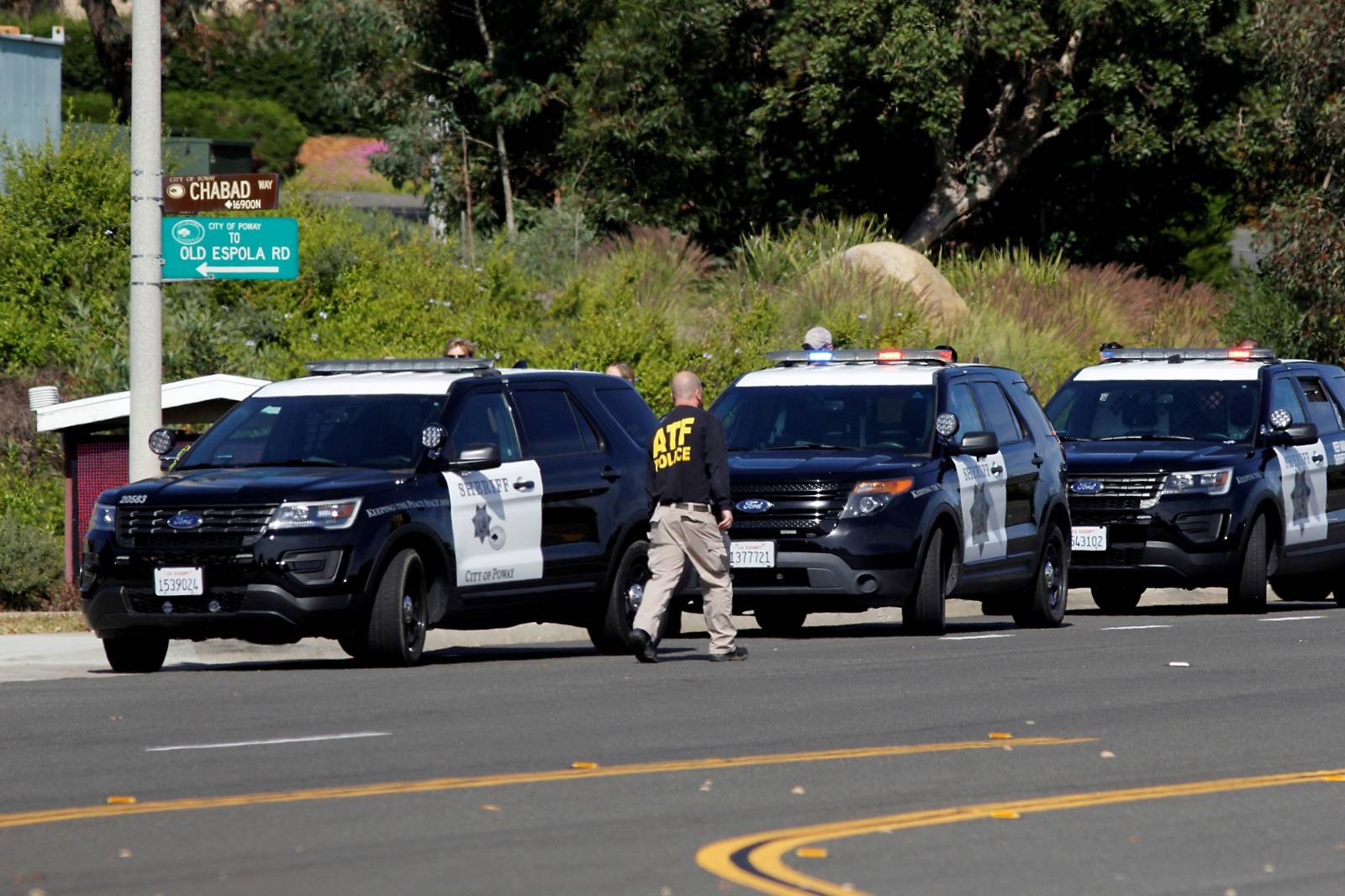 Police secure the scene of a shooting incident at the Congregation Chabad synagogue in Poway