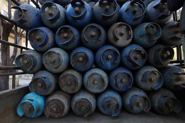 People queue to fill their gas cylinders in Damascus