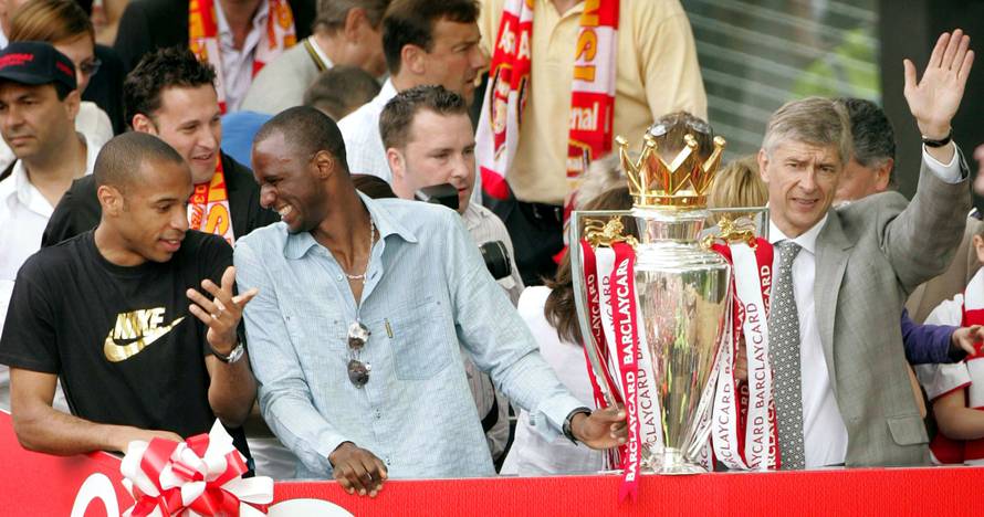 FILE PHOTO: Arsenal's Thierry Henry, Patrick Viera and manager Arsene Wenger celebrate during a victory parade