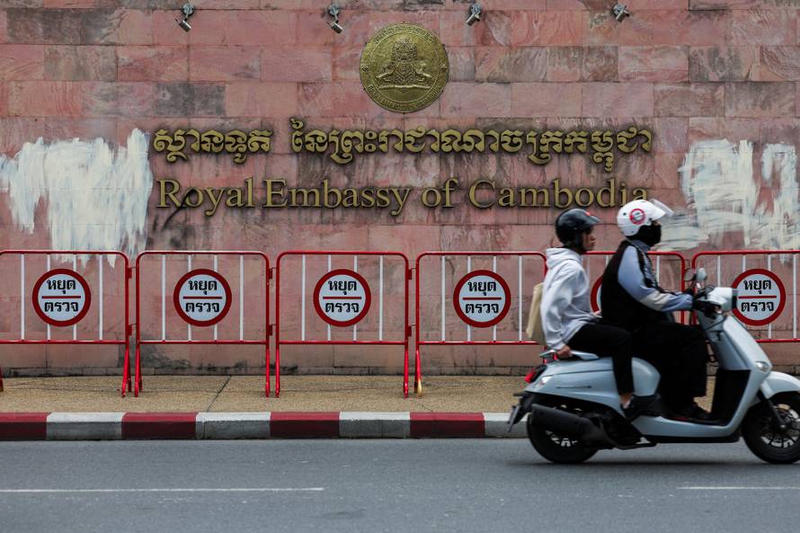 People ride a two-wheeler past the Royal Embassy of Cambodia, after Thailand has recalled its ambassador to Cambodia an expelled Cambodia's ambassador, amid border disputes in Bangkok