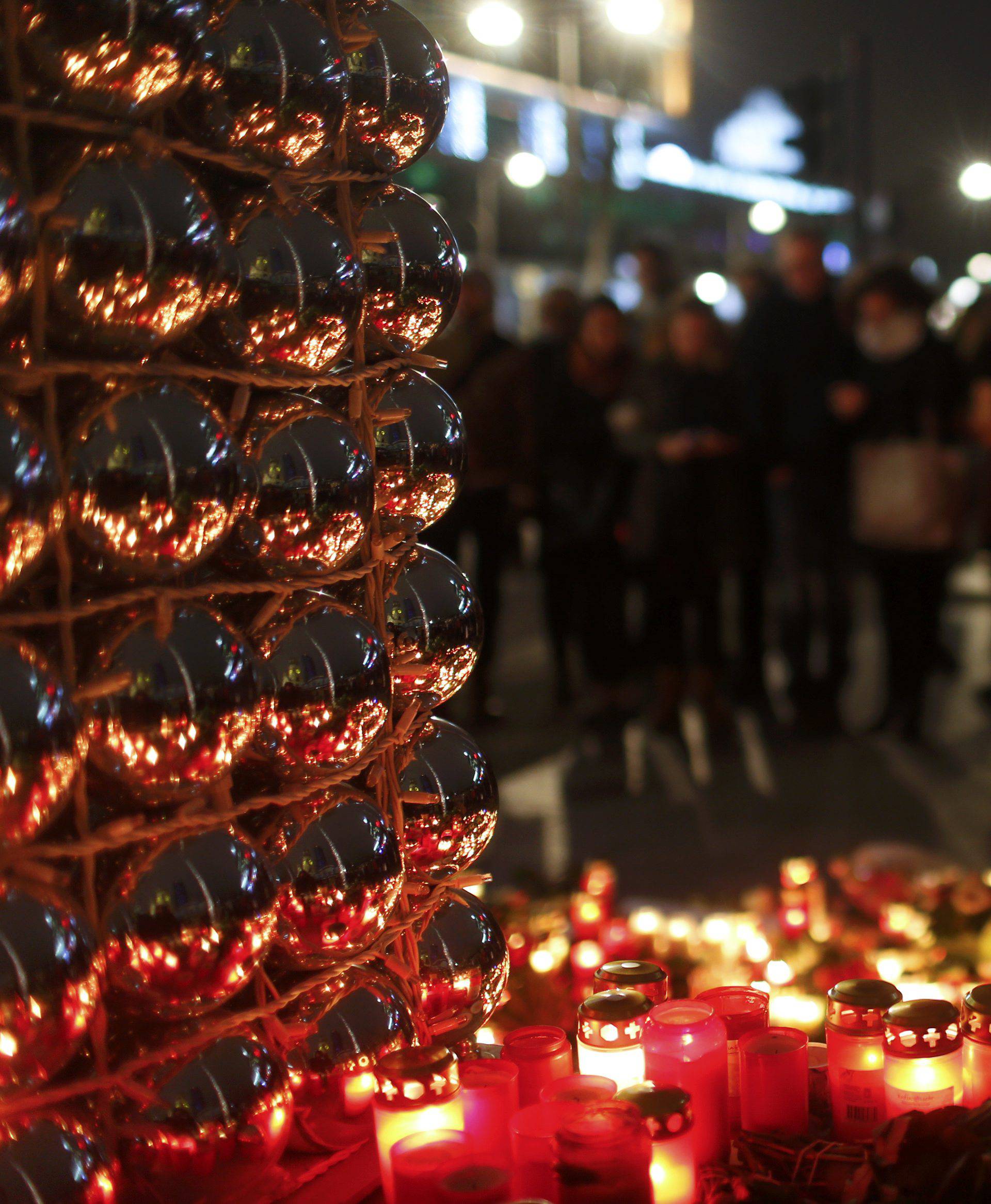 Candles burn at a Christmas market in Berlin,