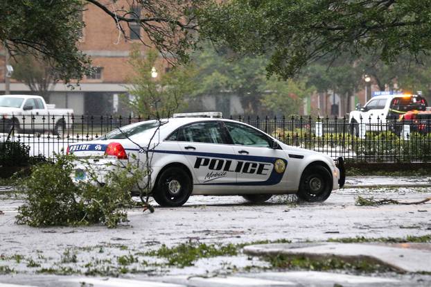 A Mobile Police Department vehicle drives down Government Streetduring Hurricane Sally in Mobile