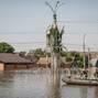 Volunteers sail on a boat during an evacuation of local residents from a flooded area after the Nova Kakhovka dam breached in Kherson