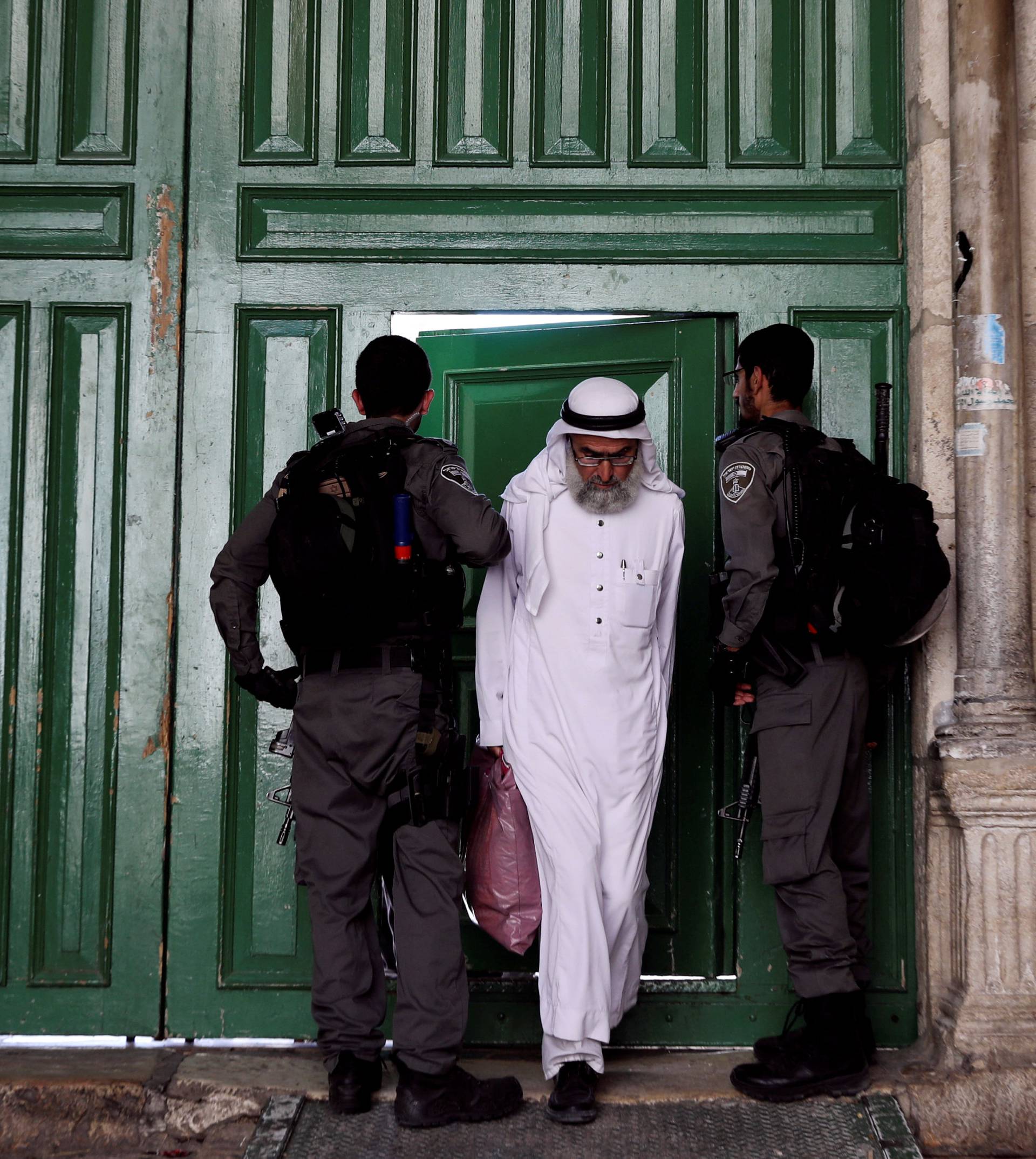 A Muslim man walks out from the compound known to Muslims as Noble Sanctuary and to Jews as Temple Mount, in Jerusalem's Old City
