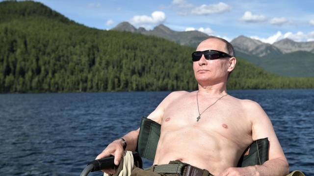 Russian President Vladimir Putin relaxes after fishing during the hunting and fishing trip which took place on August 1-3 in the republic of Tyva in southern Siberia