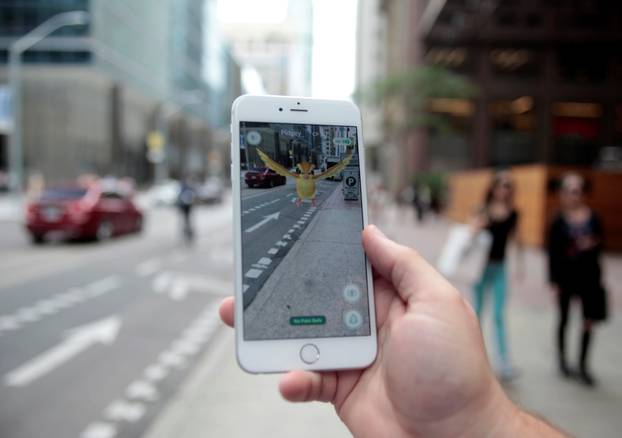 Photo illustration of a "Pidgey" Pokemon seen on the screen of the Pokemon Go mobile app 