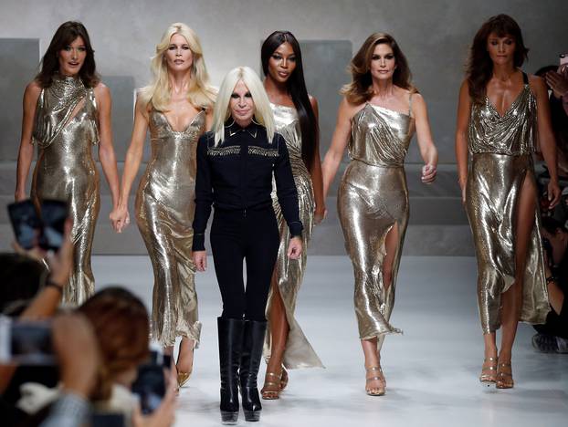 Italian designer Donatella Versace acknowledges the applause with former top models Carla Bruni, Claudia Schiffer, Naomi Campbell, Cindy Crawford and Helena Christensen at the end of Versace Spring/Summer 2018 show at the Milan Fashion Week in Milan