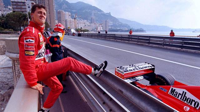 FILE PHOTO: Germany's Michael Schumacher poses next to his Ferrari during qualifying for the Monaco Grand Prix in Monte Carlo