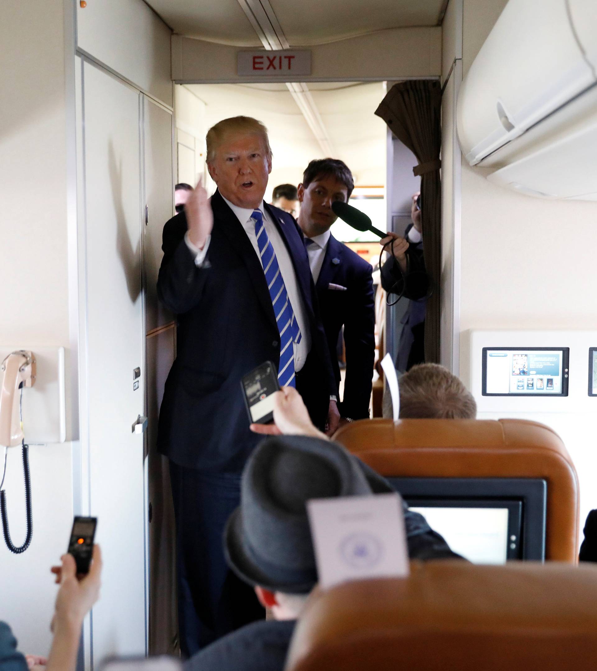 U.S. President Donald Trump speaks aboard Air Force One