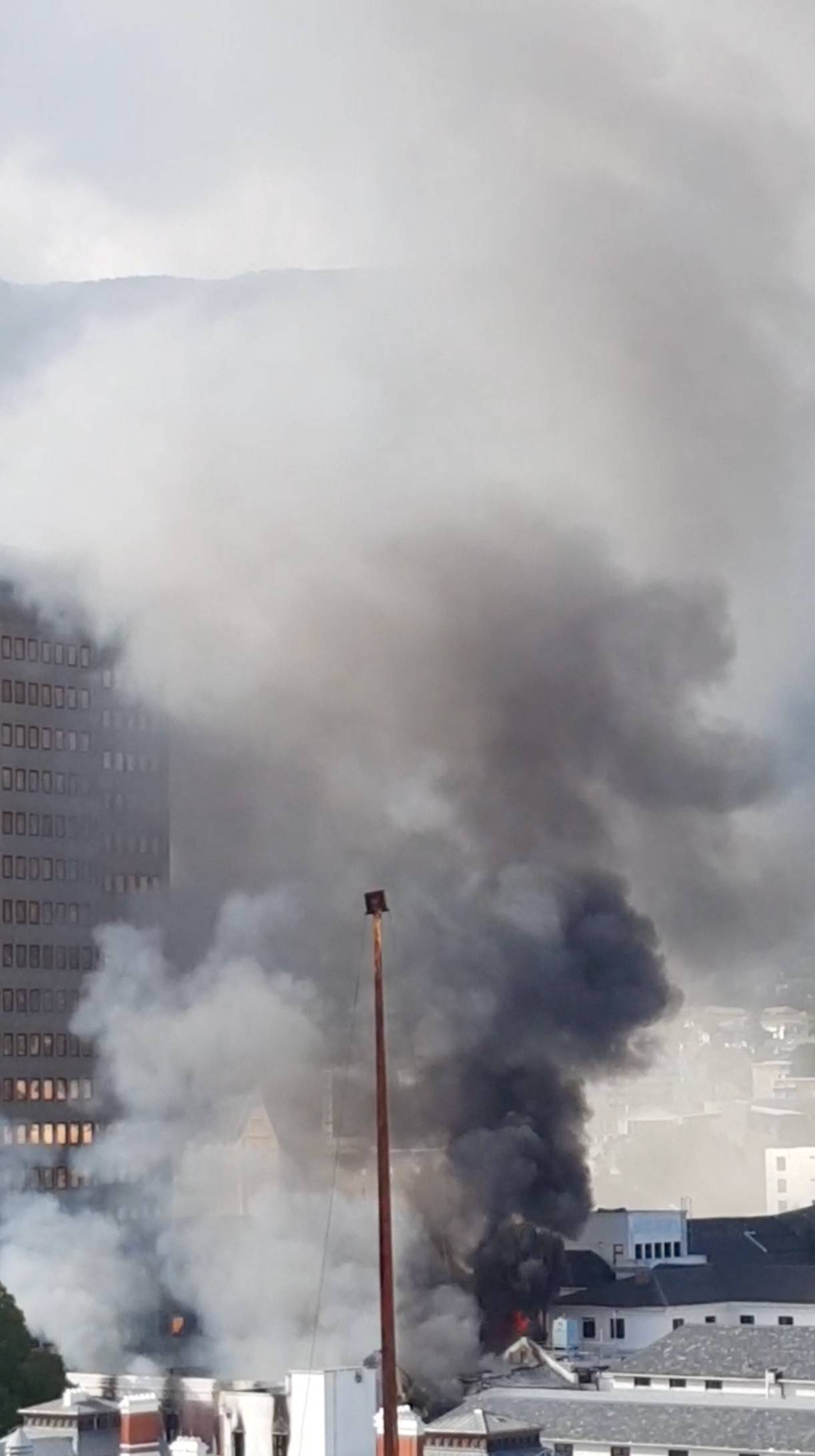 Smoke rises from a burning building in Cape Town