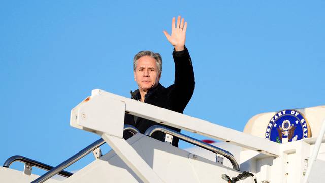 U.S. Secretary of State Antony Blinken waves as he boards a plane, en route to Saudi Arabia, at Joint Base Andrews
