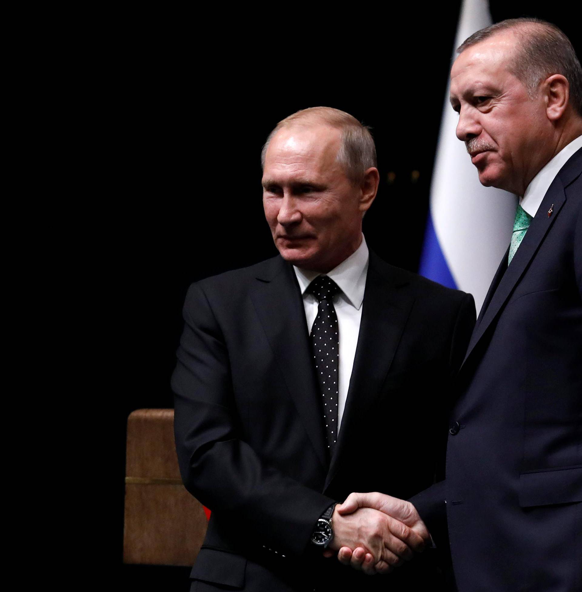 Turkish President Tayyip Erdogan shakes hands with Russian President Vladimir Putin after a news conference in Ankara