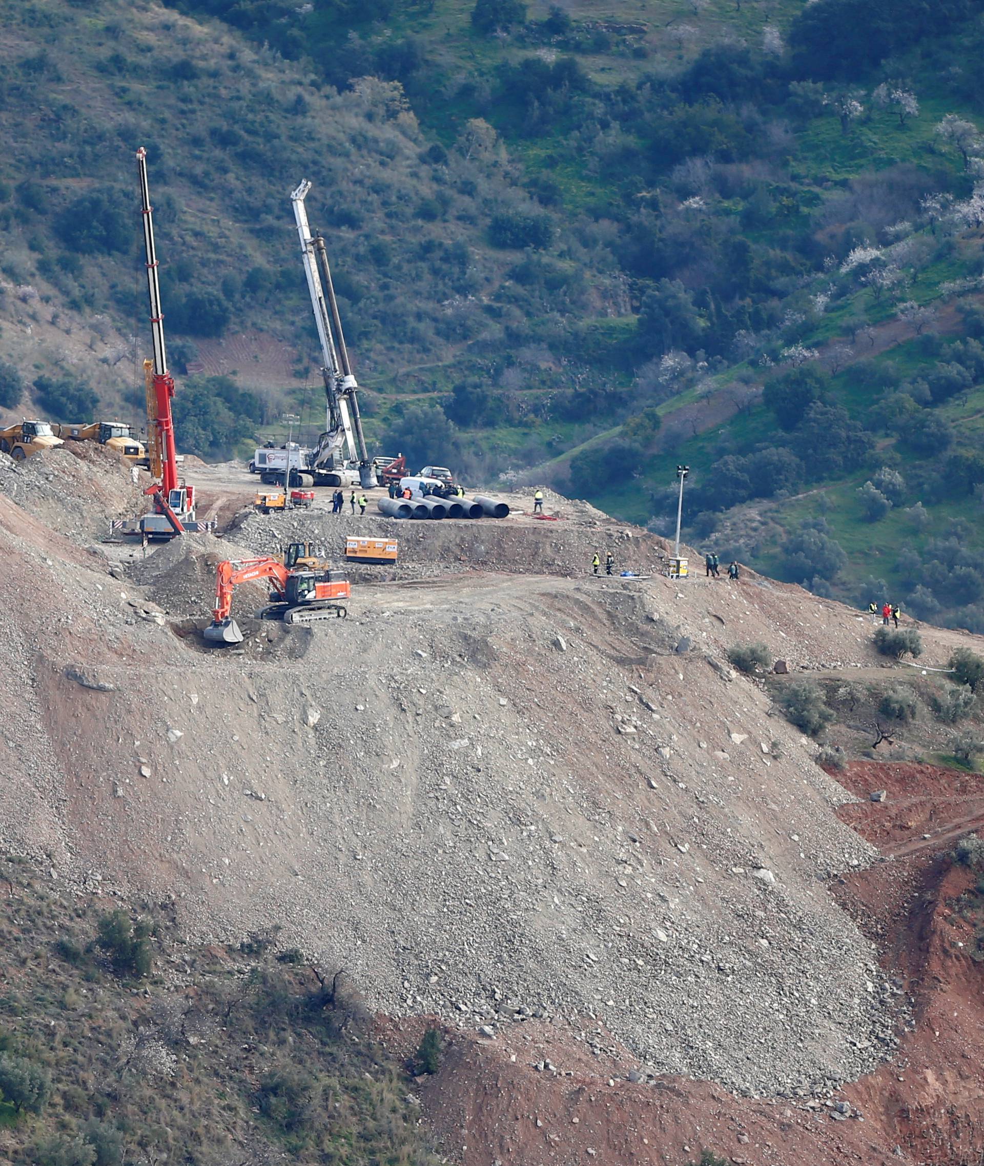 Digger removes sand after failing the placement of the steel tubes into the drilled well at the area where Julen fell into a deep well in Totalan