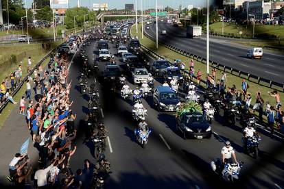The hearse carrying the casket of soccer legend Diego Maradona drives to the cemetery in Buenos Aires
