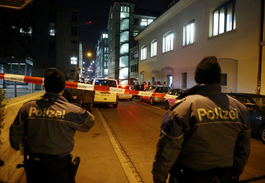 Police stand outside an Islamic center in central Zurich
