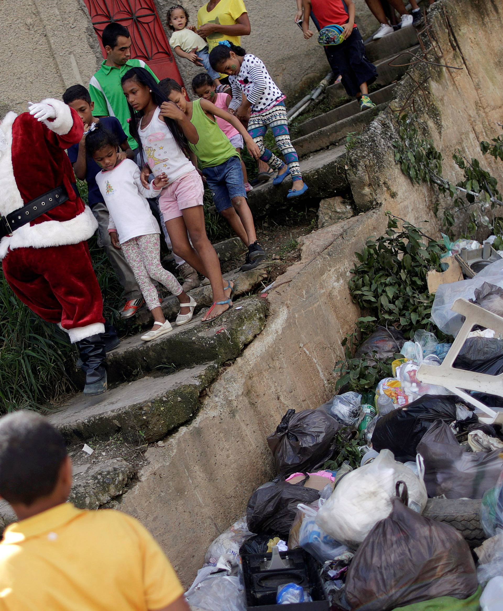 Santa Claus greets a child during a visit to residents of the slum of Petare in Caracas