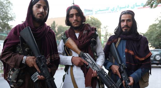 Taliban soldiers pose for a photo in Kabul