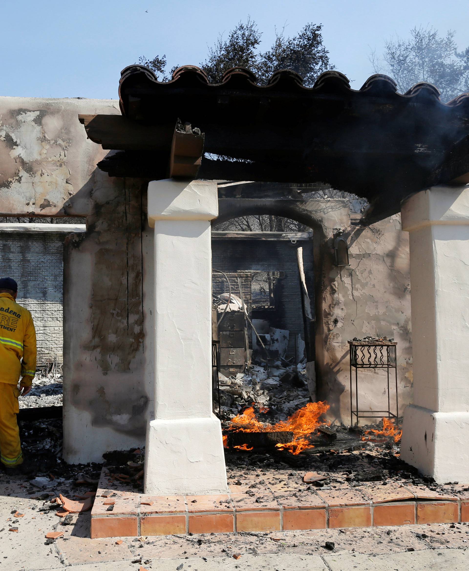A firefighter checks a home that was burned in the so-called Sand Fire in the Angeles National Forest near Los Angeles
