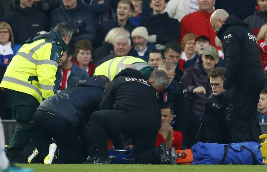 Liverpool's Philippe Coutinho receives medical attention after sustaining an injury