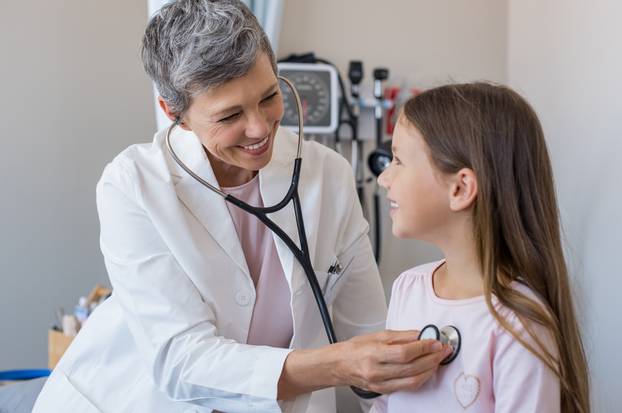 Doctor examining girl